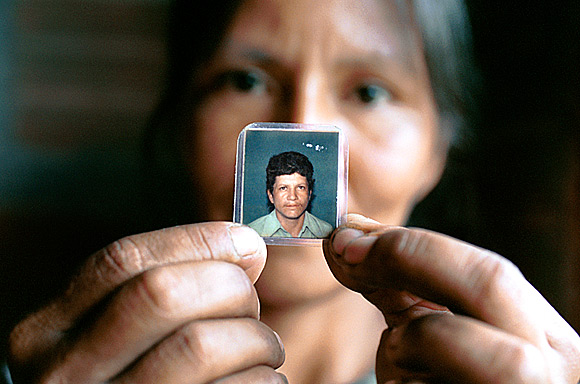 photograph of widow with small photo of her husband